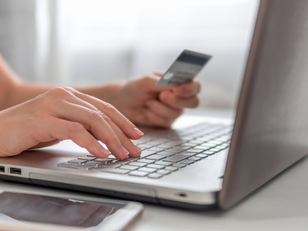 Online shopping concept. Close-up woman's hands holding credit card. 