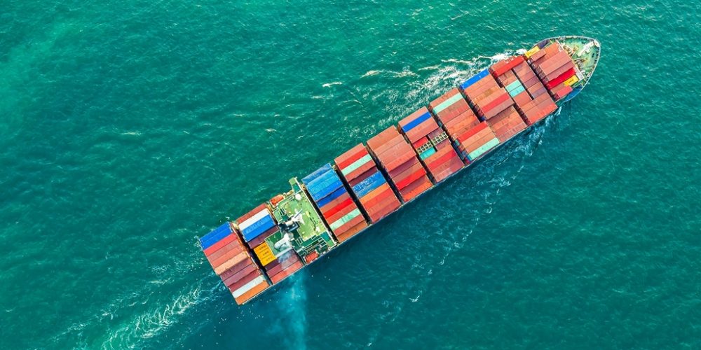 Aerial view of a cargo ship carrying container for business import and export logistic supply chain