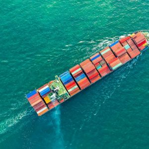 Aerial view of a cargo ship carrying container for business import and export logistic supply chain